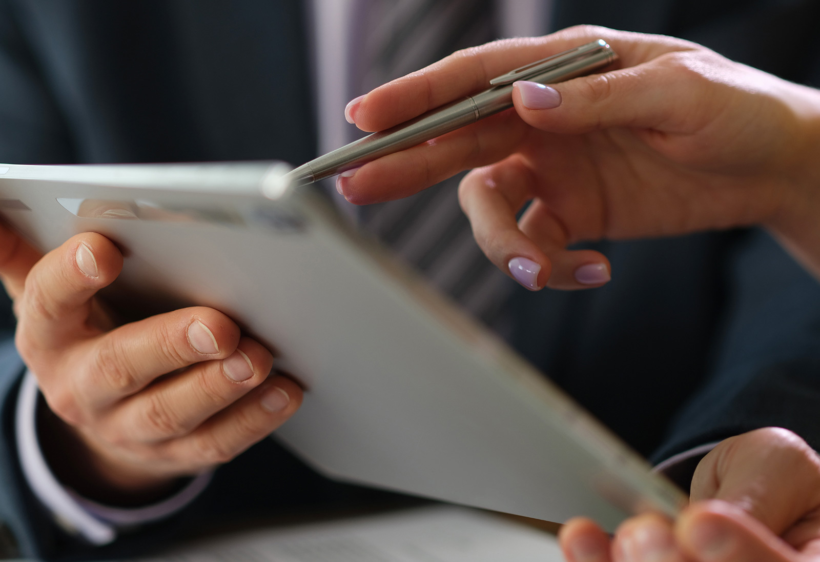 Close up of business people looking at a tablet together