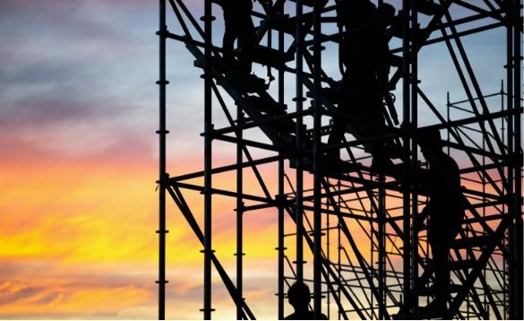 Construction workers climbing scaffolding