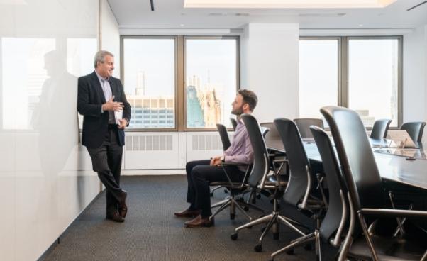 Two employees talking a meeting room